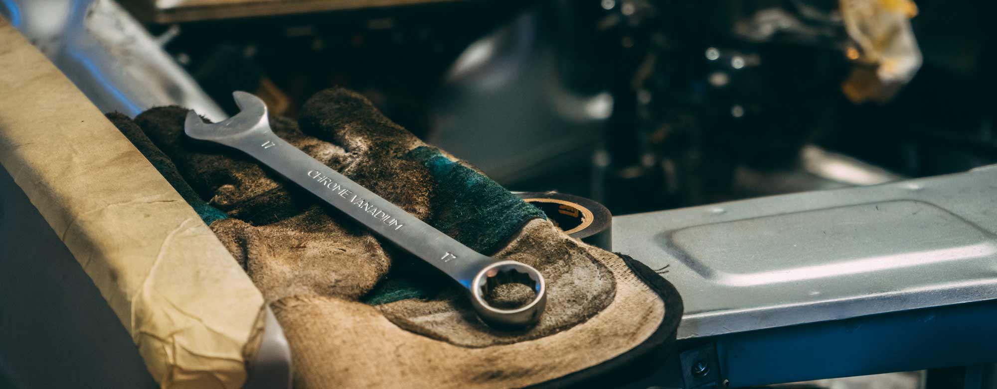 Mechanic wrench and greasy glove