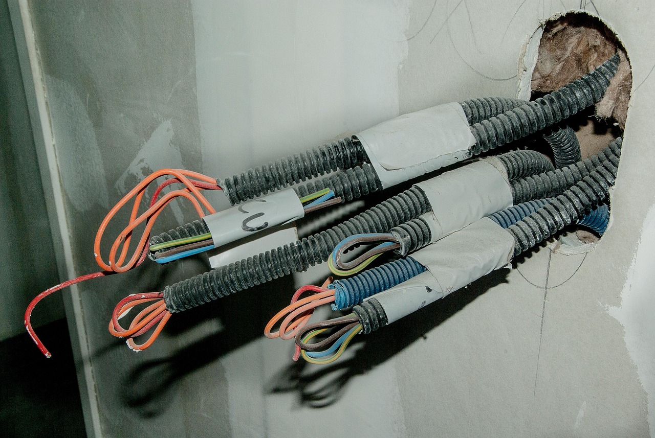 Image of cables pulling out of a wall